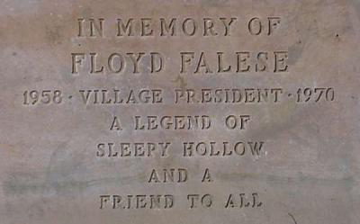 Memorial plaque says "In memory of Floyd Falese 1958 - Village President - 1970 - A legend of Sleepy Hollow and a Friend to All"