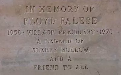 Memorial plaque says "In memory of Floyd Falese 1958 - Village President - 1970 - A legend of Sleepy Hollow and a Friend to All"